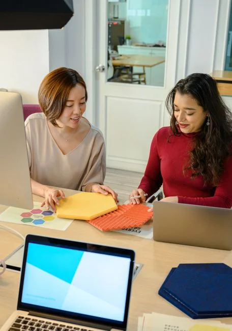 Group of designers collaborating in modern office space with computer.